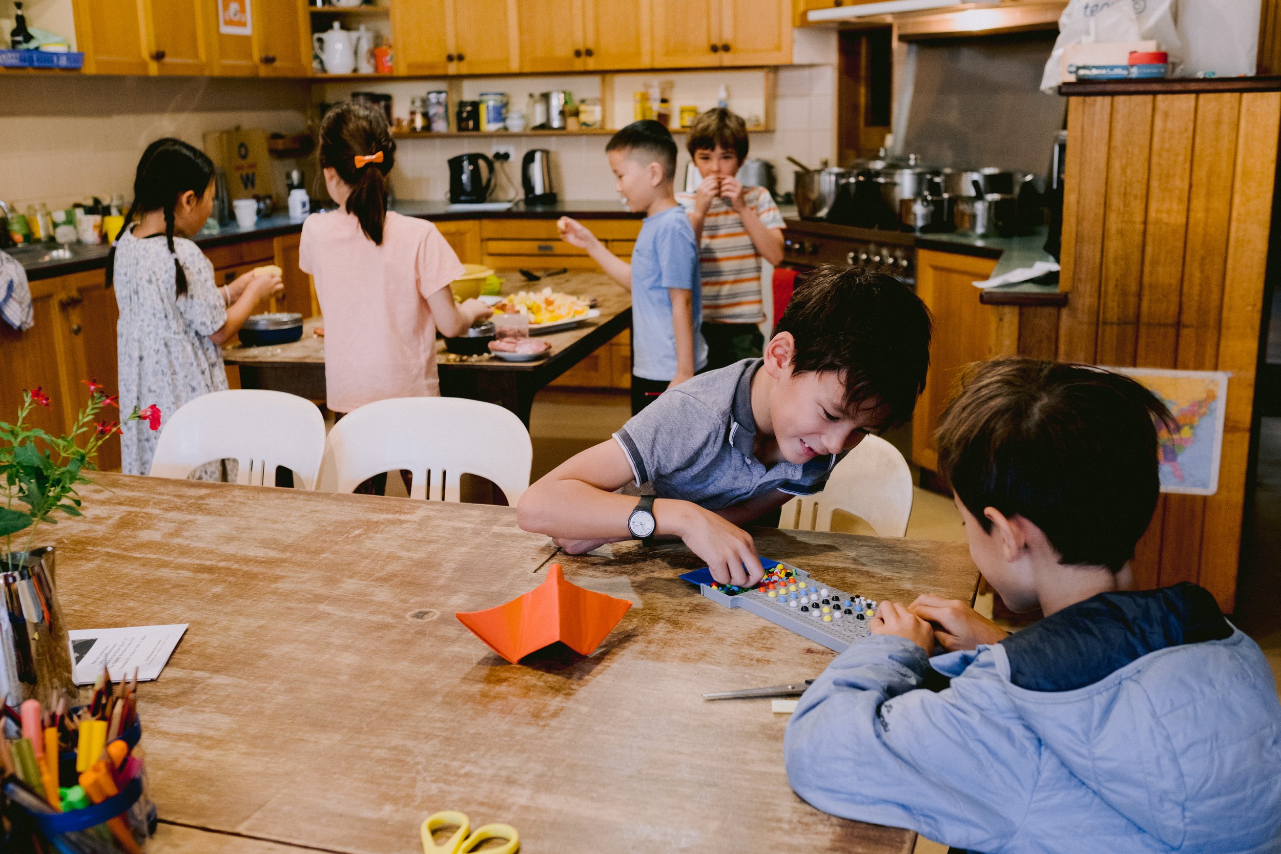 Boys playing board game in the school kitchen