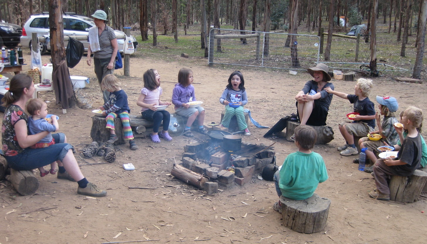 laughs around a campfire